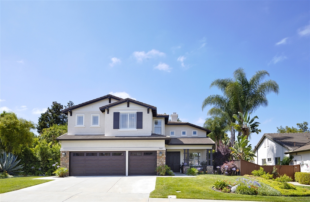 a front view of house with yard outdoor seating and green space