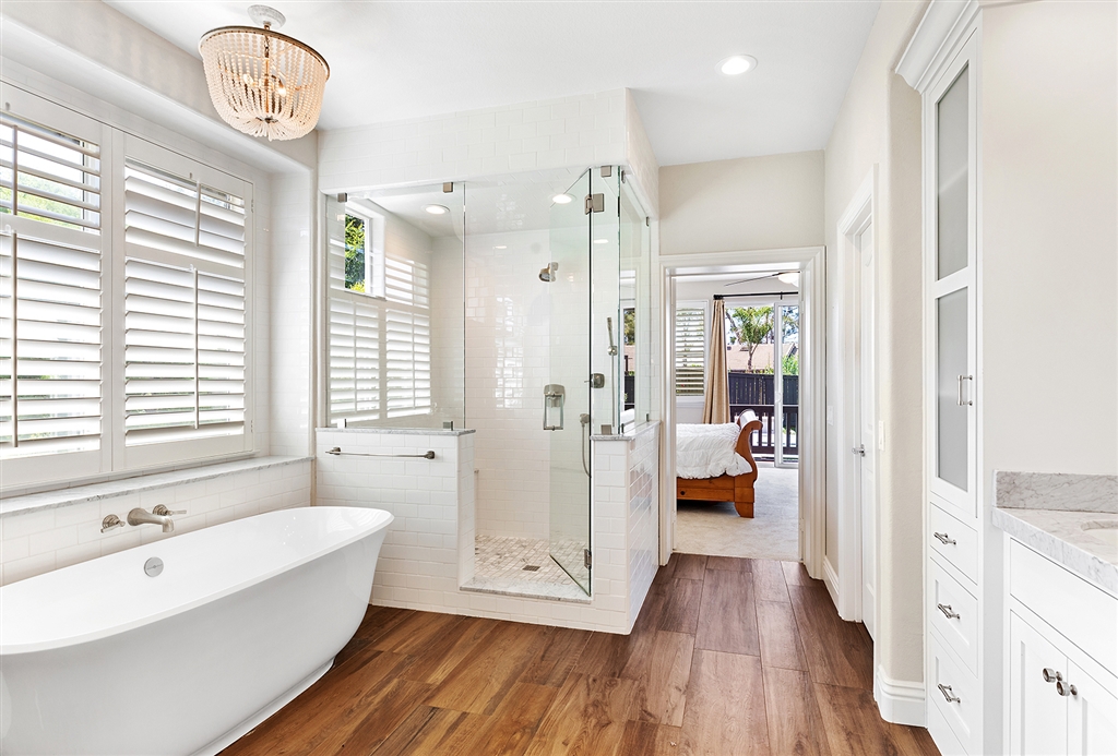 3445 Camino Alegre Carlsbad, CA 92009 - Photo 13 of 25 a spacious bathroom with a bathtub shower and a sink
