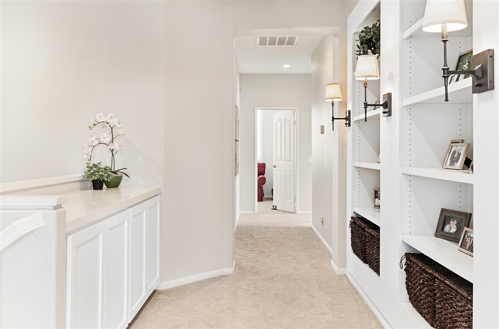 3445 Camino Alegre Carlsbad, CA 92009 - Photo 15 of 25 a hallway with white cabinets and window