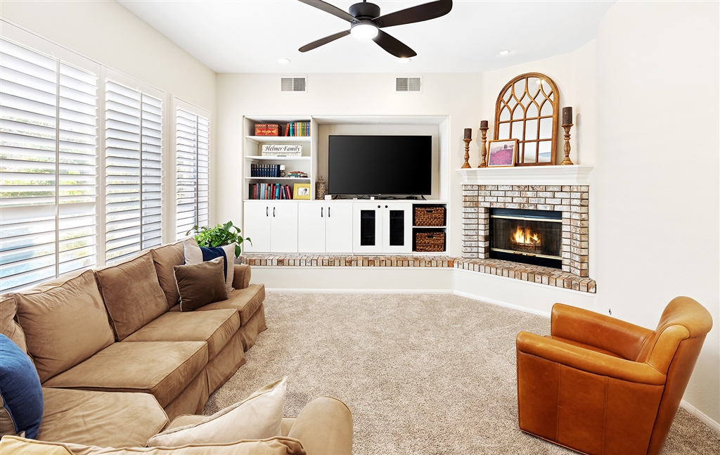 3445 Camino Alegre Carlsbad, CA 92009 - Photo 5 of 25 a living room with furniture fireplace and flat screen tv