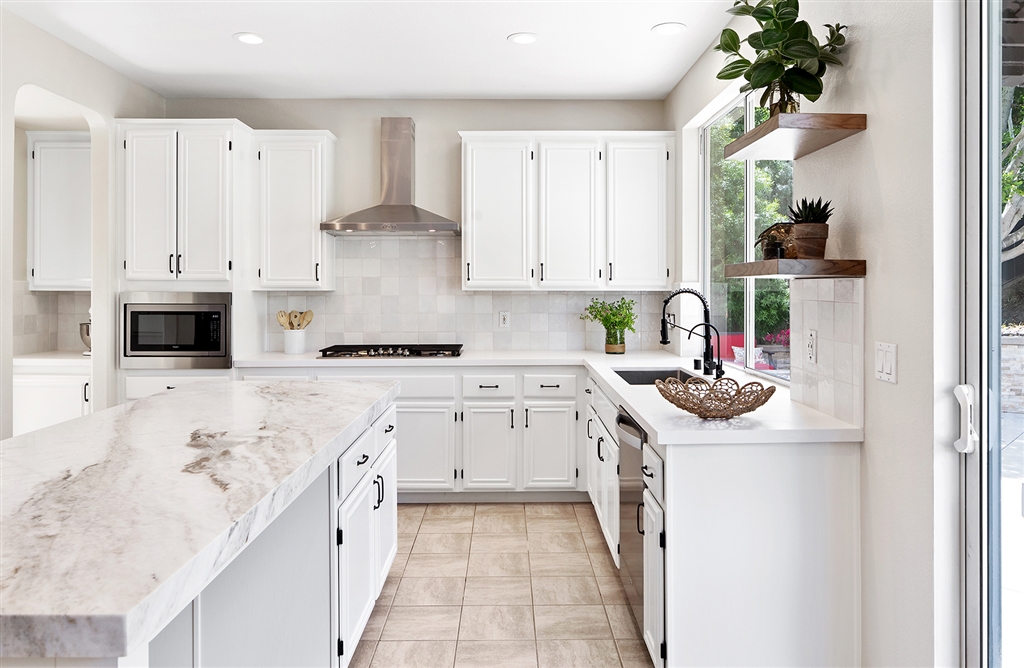 3445 Camino Alegre Carlsbad, CA 92009 - Photo 7 of 25 a kitchen with stainless steel appliances granite countertop a stove and a white cabinets