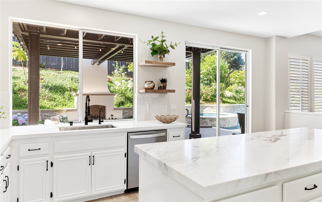 3445 Camino Alegre Carlsbad, CA 92009 - Photo 9 of 25 a kitchen with a sink and large window