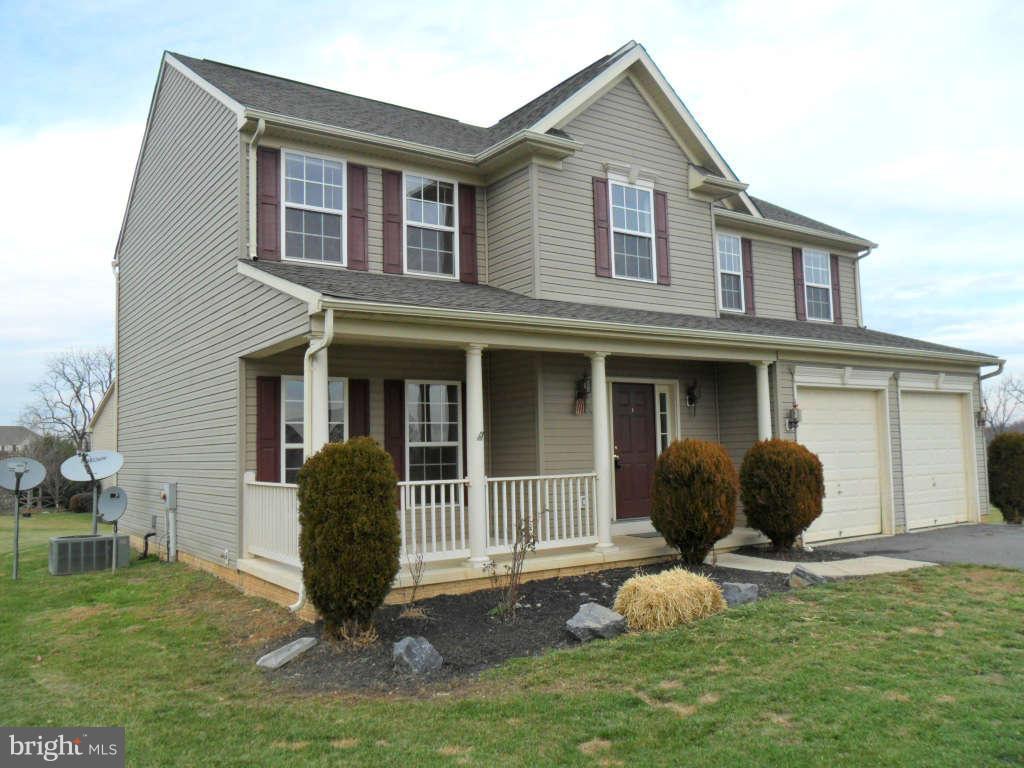 103 Ripe Berry Lane Martinsburg, WV 25403 - Photo 2 of 19 a front view of a house with a garden