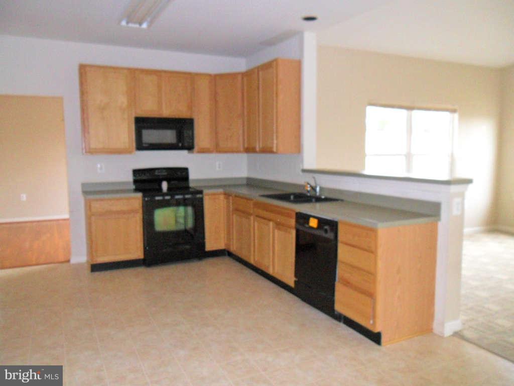 103 Ripe Berry Lane Martinsburg, WV 25403 - Photo 8 of 19 a kitchen with stainless steel appliances granite countertop a stove a sink and a microwave