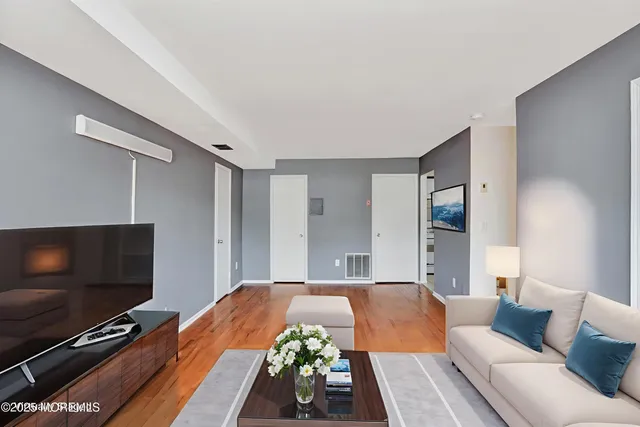 a spacious bedroom with a bed and a flat screen tv