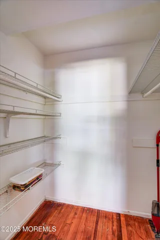 a view of walk in closet with empty racks