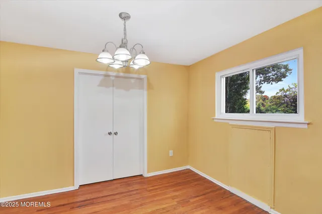 a view of a chandelier fan and wooden floor