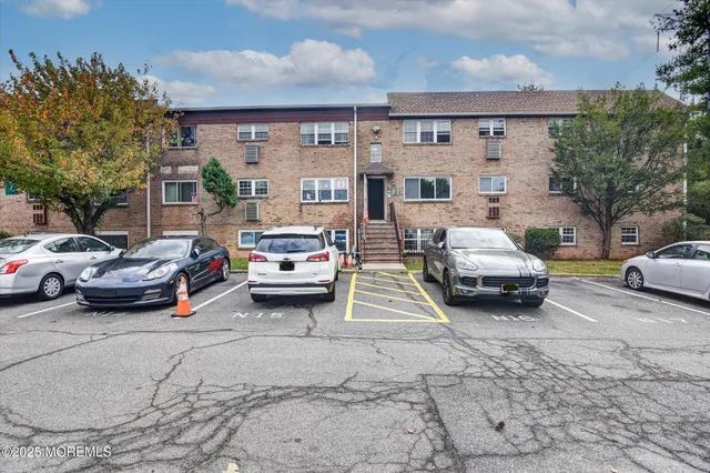 a view of a cars park in front of a building