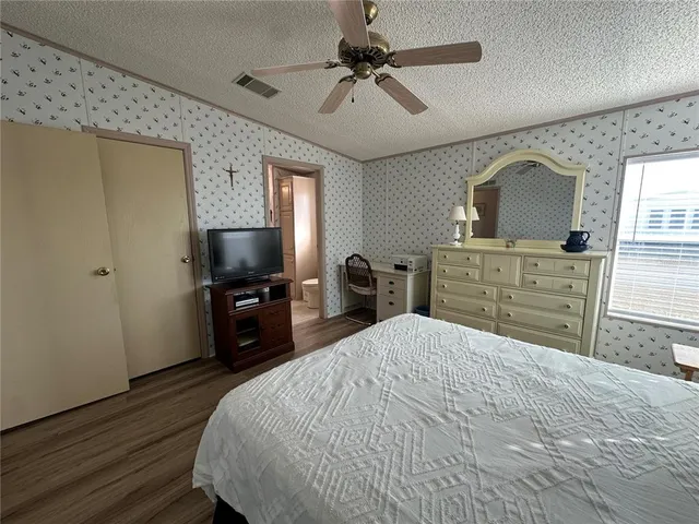 a bedroom with a bed and a television