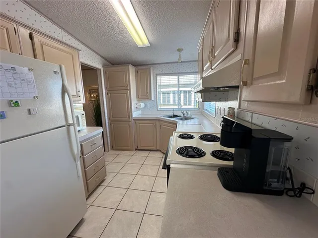 a kitchen with a refrigerator and a sink