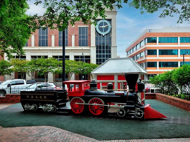 a car parked in front of a brick house with wooden fence