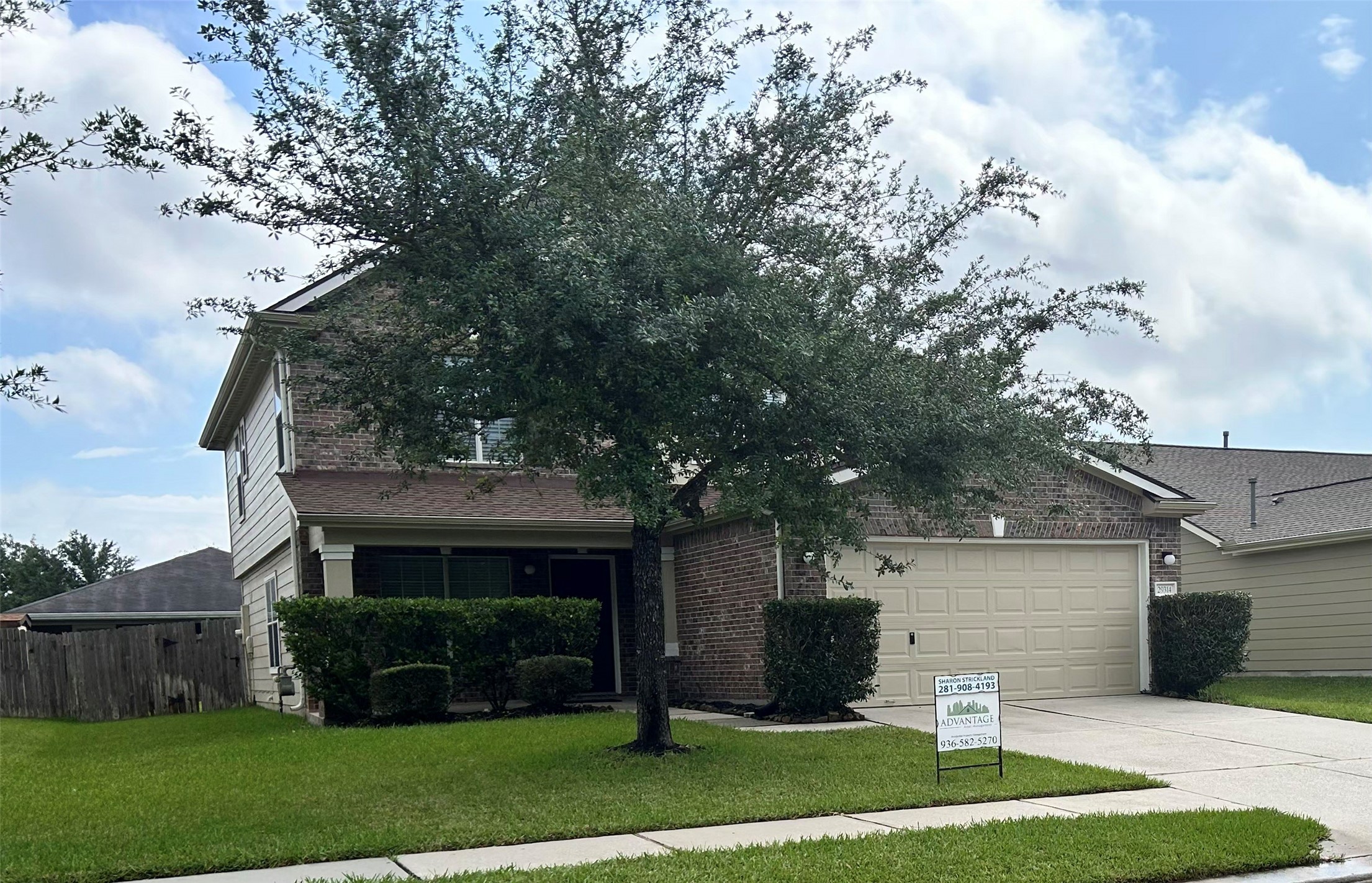 29314 Legends Bluff Drive Spring, TX 77386 - Photo 2 of 31 a view of a yard in front of a house with plants and large tree