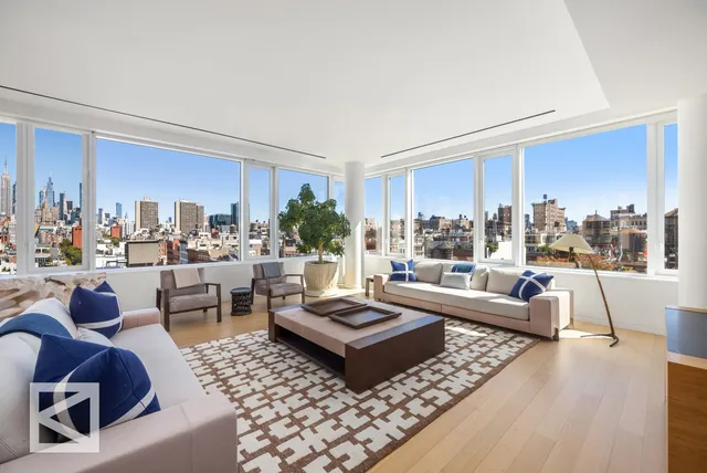 a dining area with furniture and a large window