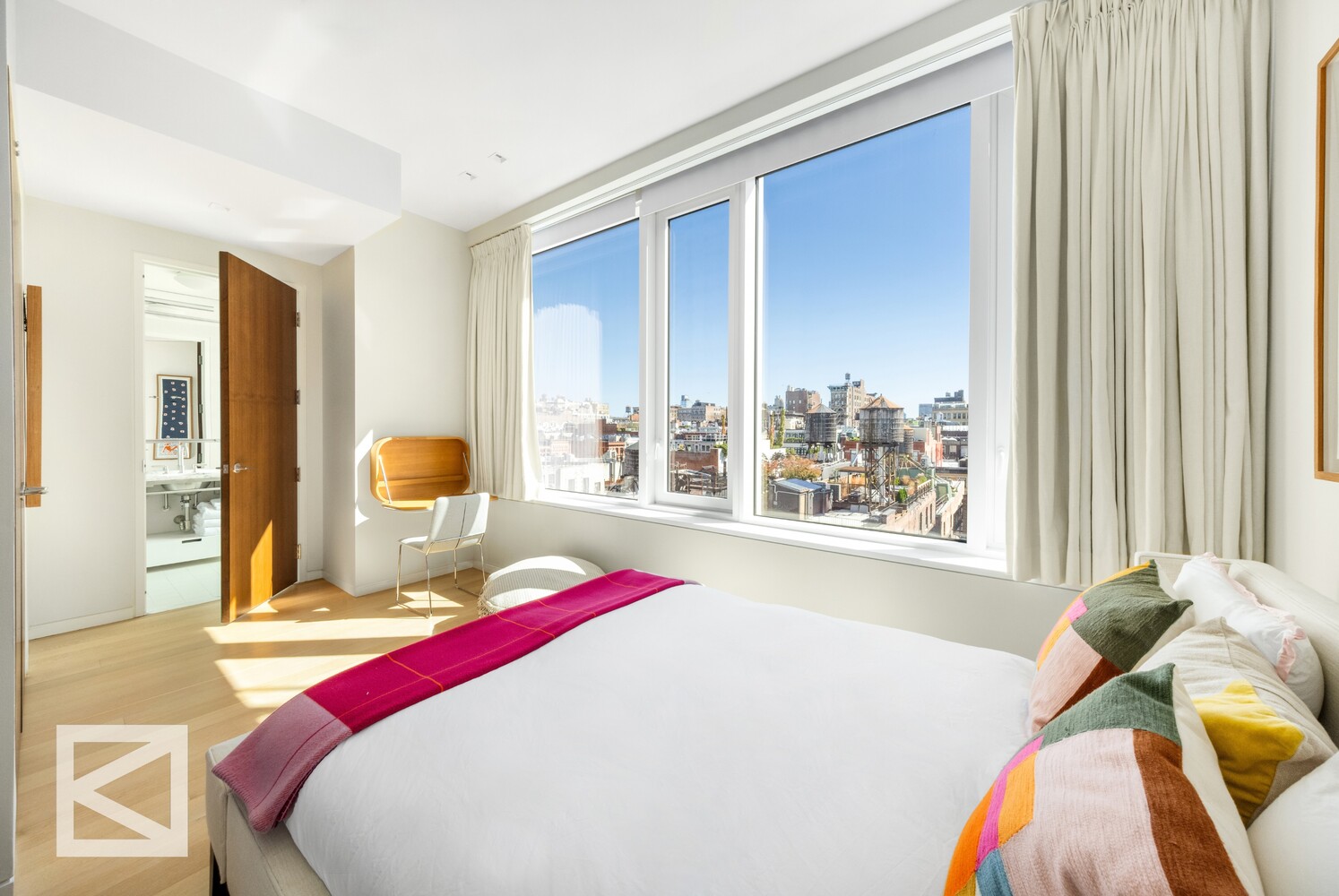 350 West Broadway, Unit PH Manhattan, NY 10013 - Photo 15 of 32 a bed sitting in a bedroom next to a window