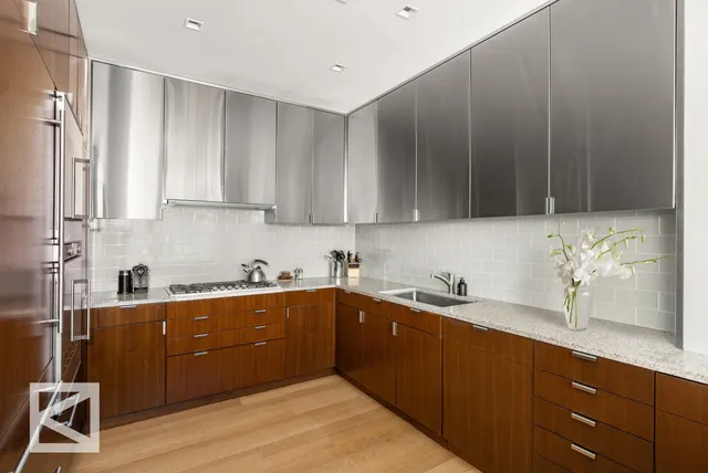 a living room with furniture a chandelier and a dining table