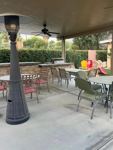 a view of a porch with furniture and a yard