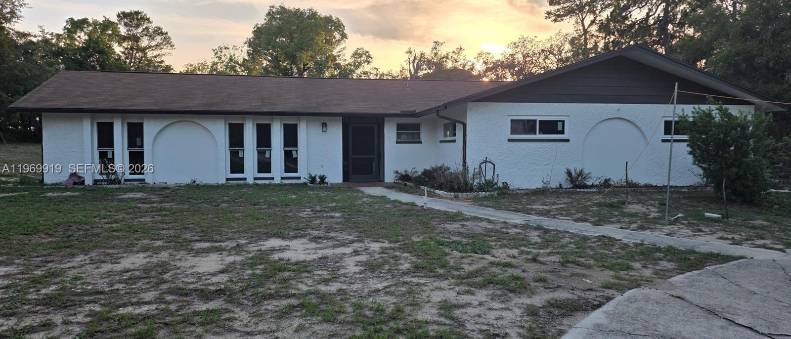 18227 Branch Road Hudson, FL 34667 - Photo 17 of 17 a front view of a house with a yard