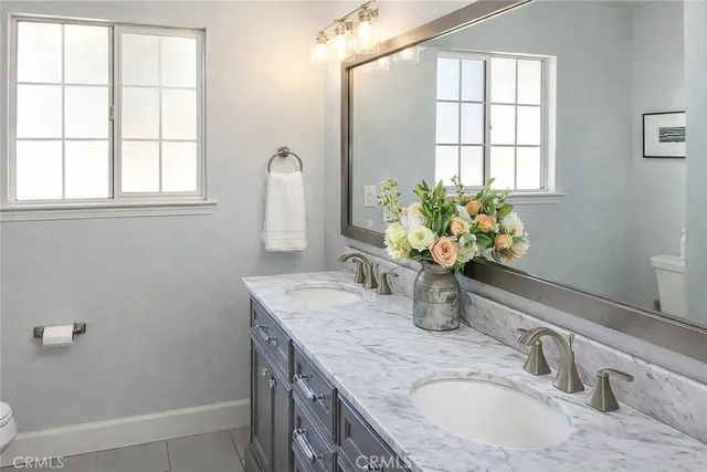 a bathroom with a granite countertop sink a mirror and a shower