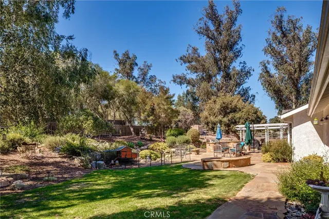 a view of a patio with table and chairs under an umbrella