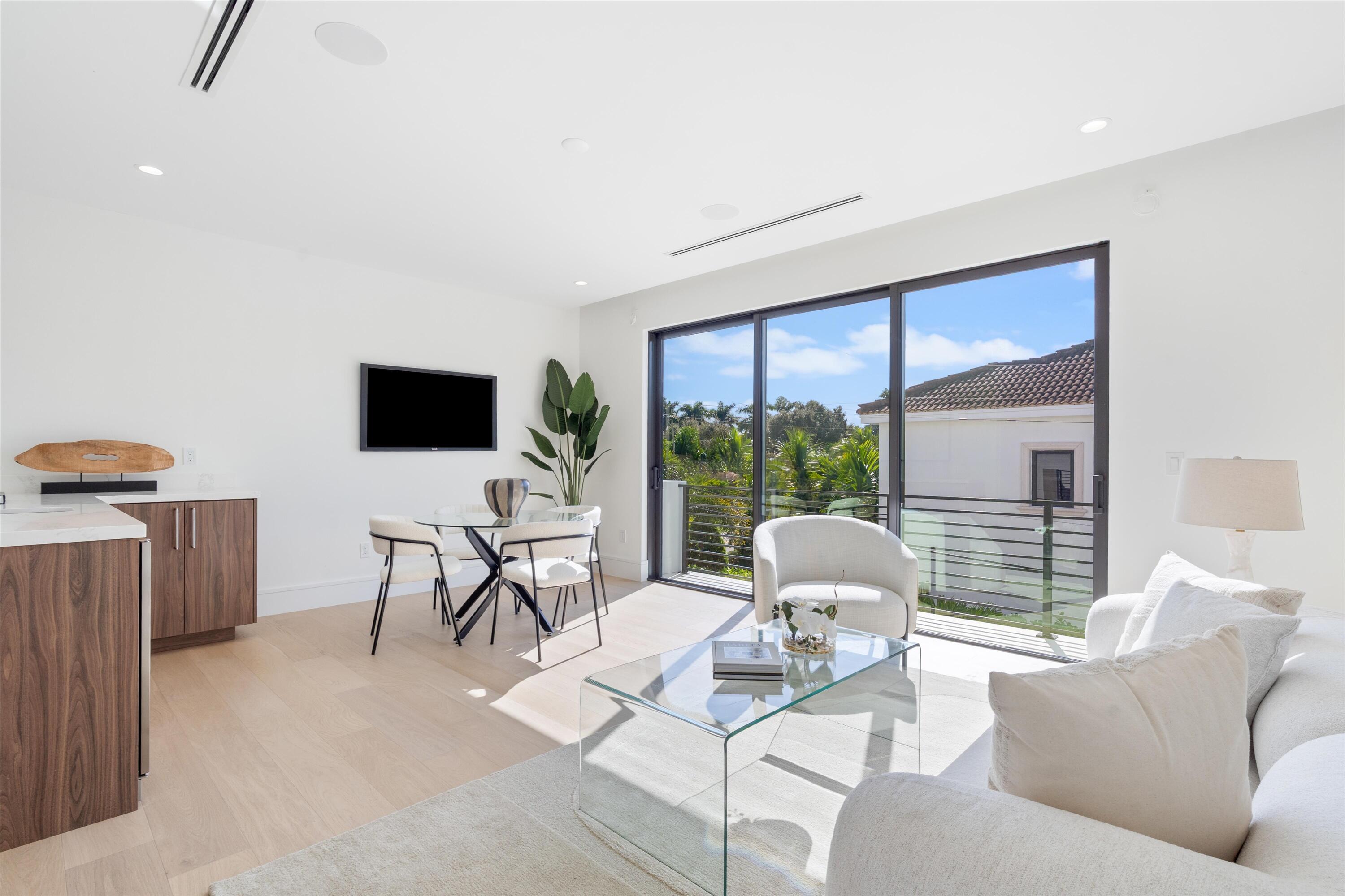 498 Northeast 6th Street Boca Raton, FL 33432 - Photo 26 of 60 a living room with furniture tv and a floor to ceiling window