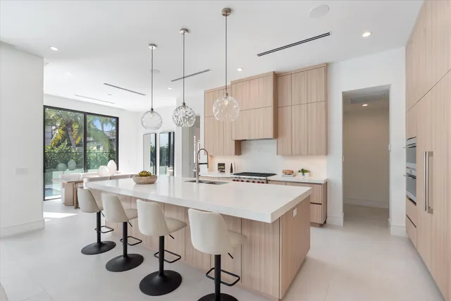 a kitchen with a sink a stove a refrigerator and wooden floor