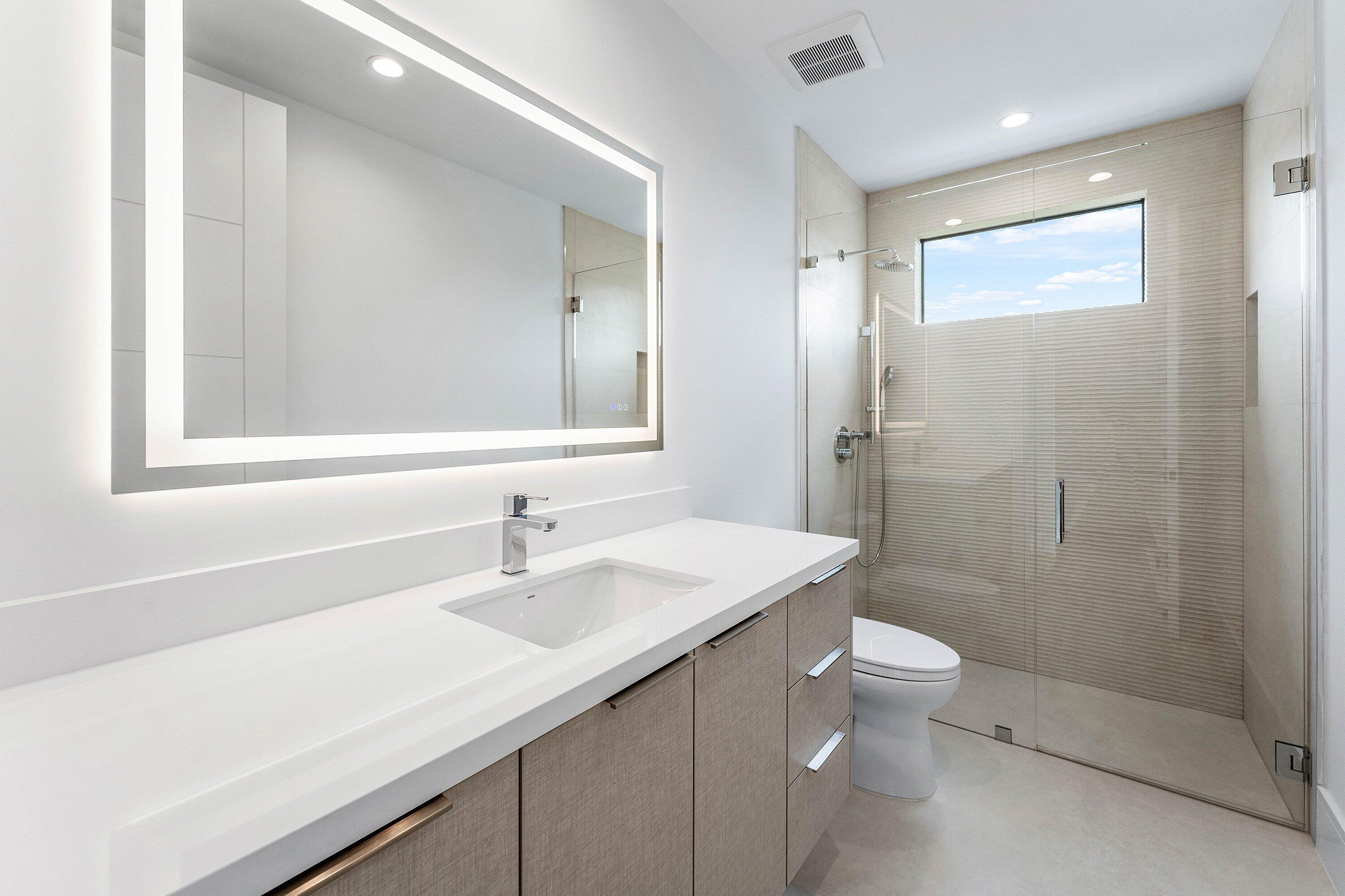 498 Northeast 6th Street Boca Raton, FL 33432 - Photo 37 of 60 a bathroom with a sink a toilet and shower