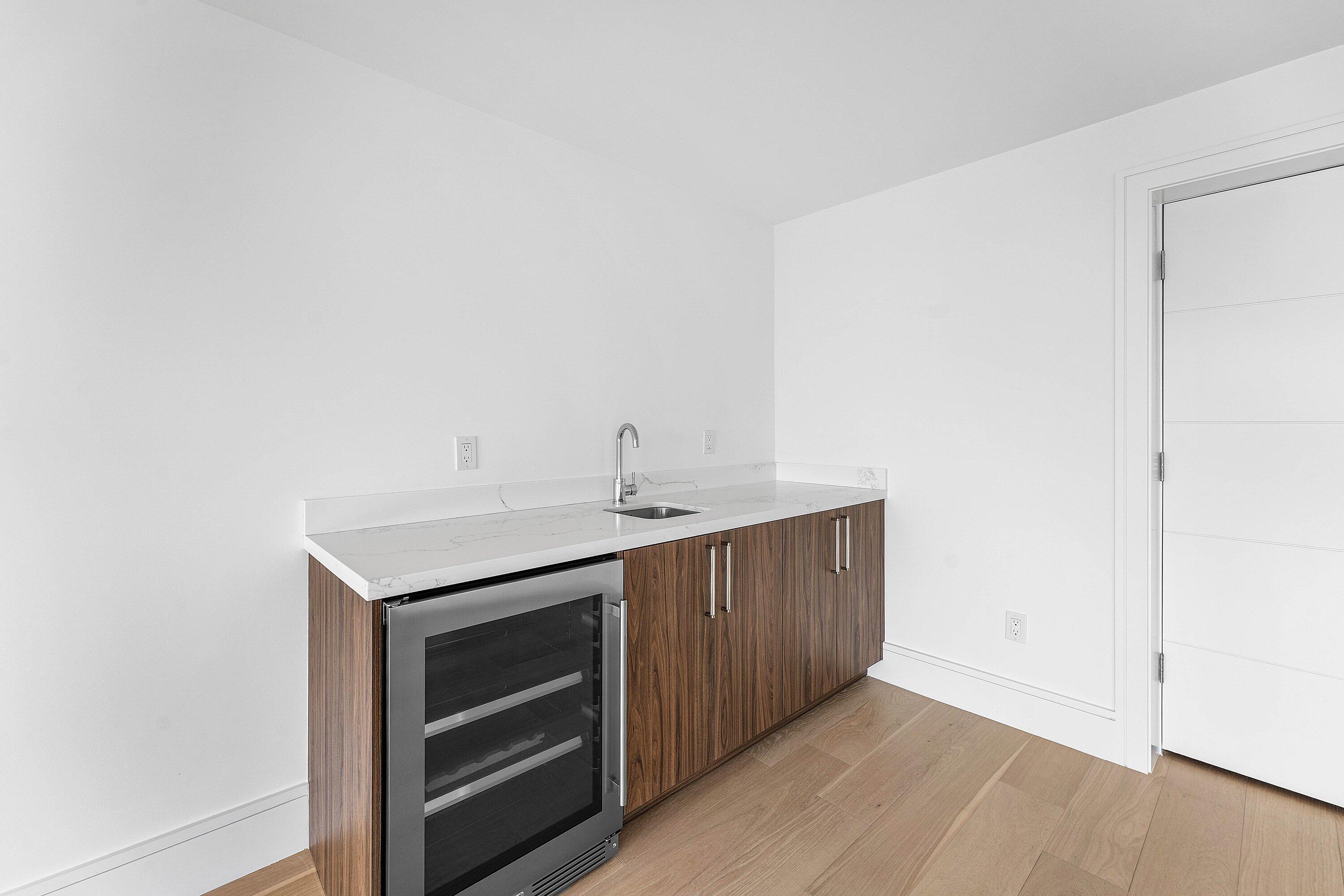 498 Northeast 6th Street Boca Raton, FL 33432 - Photo 41 of 60 a kitchen with a sink cabinets and a microwave