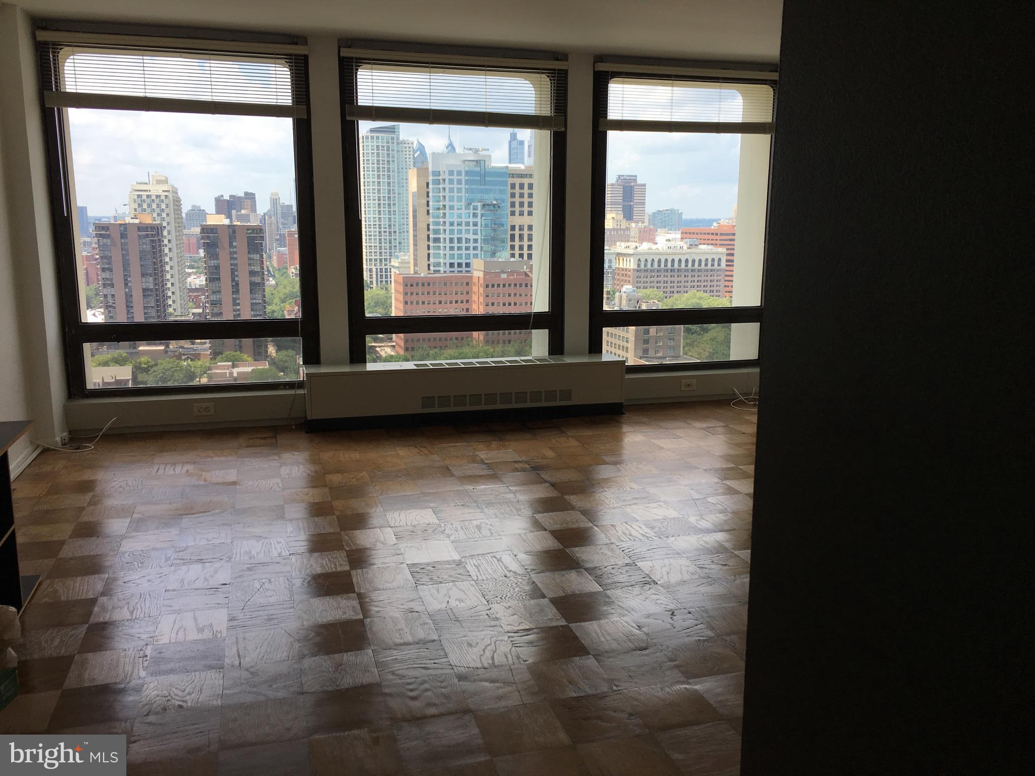 210 Locust Street, Unit 27F Philadelphia, PA 19106 - Photo 2 of 17 a view of an empty room with a floor to ceiling window and a floor to ceiling window