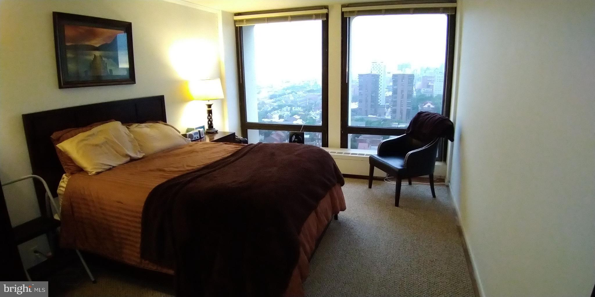 210 Locust Street, Unit 27F Philadelphia, PA 19106 - Photo 6 of 17 a bedroom with a bed and a large window