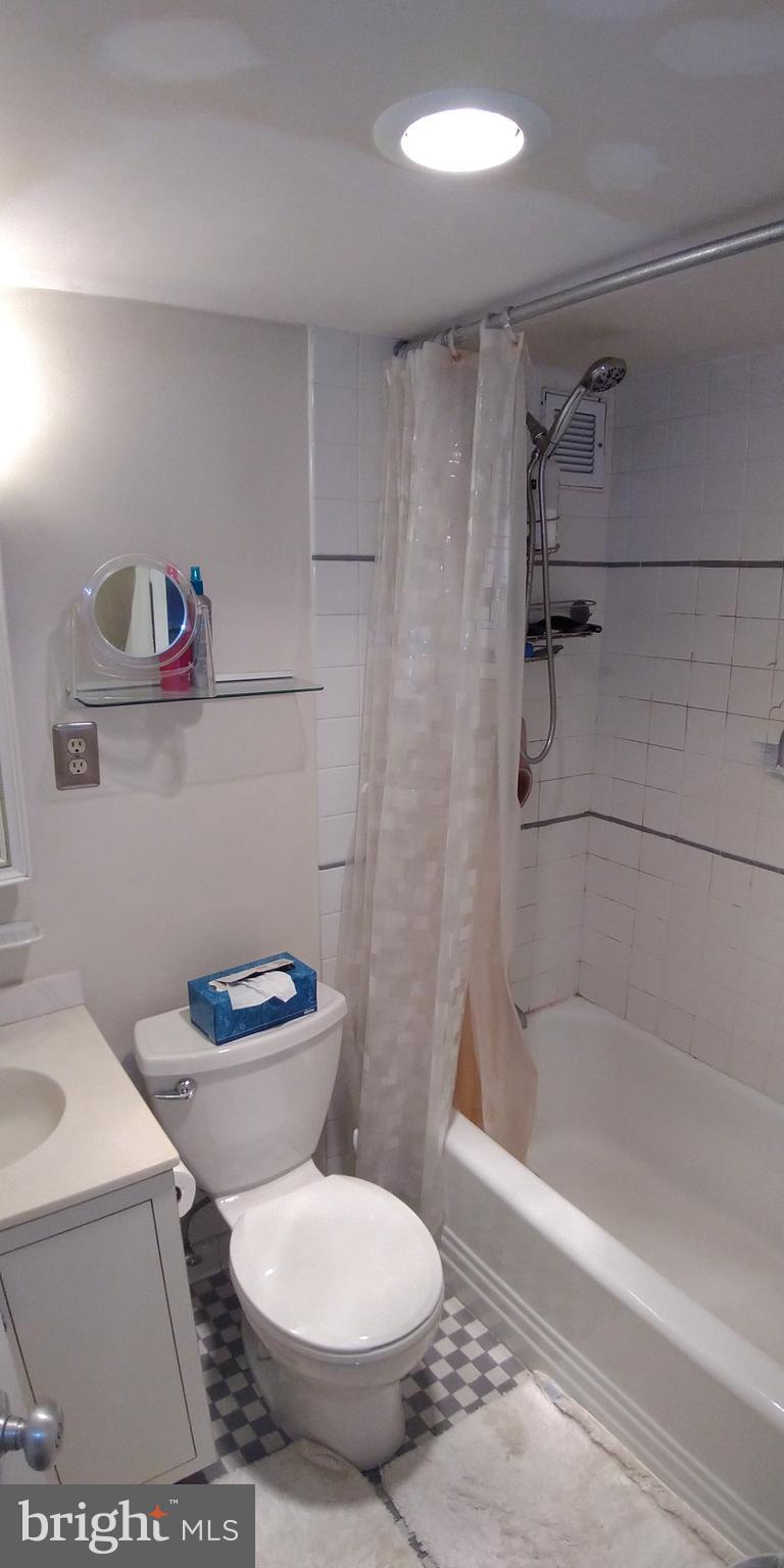 210 Locust Street, Unit 27F Philadelphia, PA 19106 - Photo 9 of 17 a white toilet sitting next to a bath tub