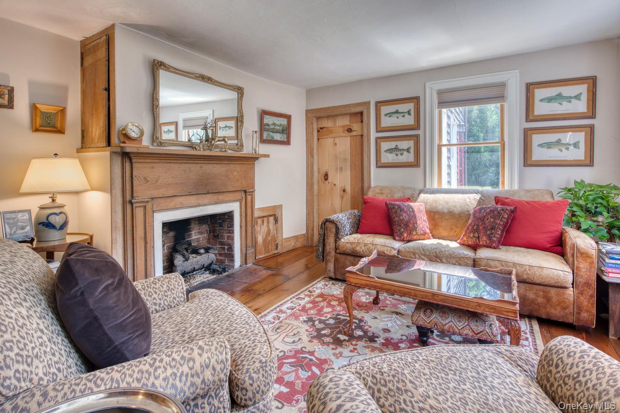 7635 Main Bayview Road Southold, NY 11971 - Photo 16 of 20 a living room with furniture and a fireplace
