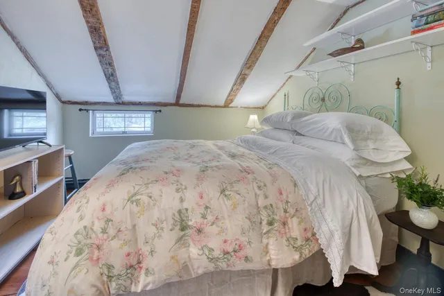 a bed sitting in a bedroom next to a window