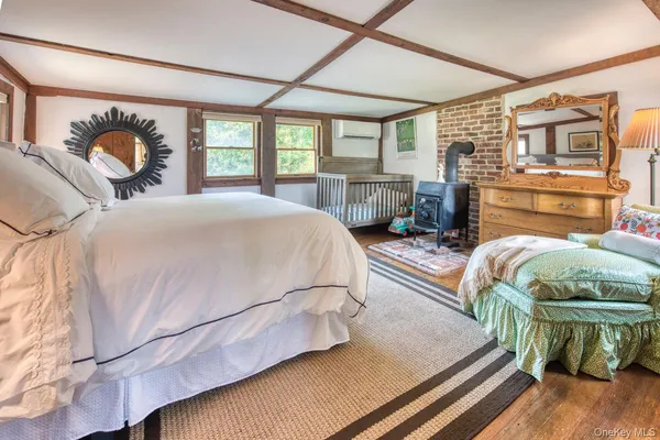 a bedroom with two beds and a flat screen tv