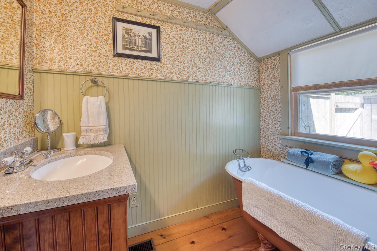 7635 Main Bayview Road Southold, NY 11971 - Photo 9 of 20 a bathroom with a sink mirror vanity and a toilet