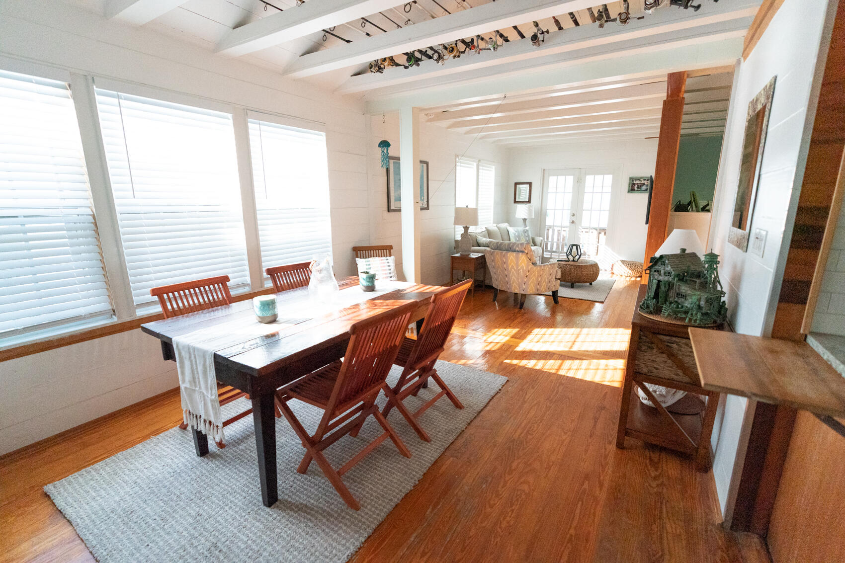 198 Beach Road Tavernier, FL 33070 - Photo 3 of 15 a view of a dining room with furniture and wooden floor