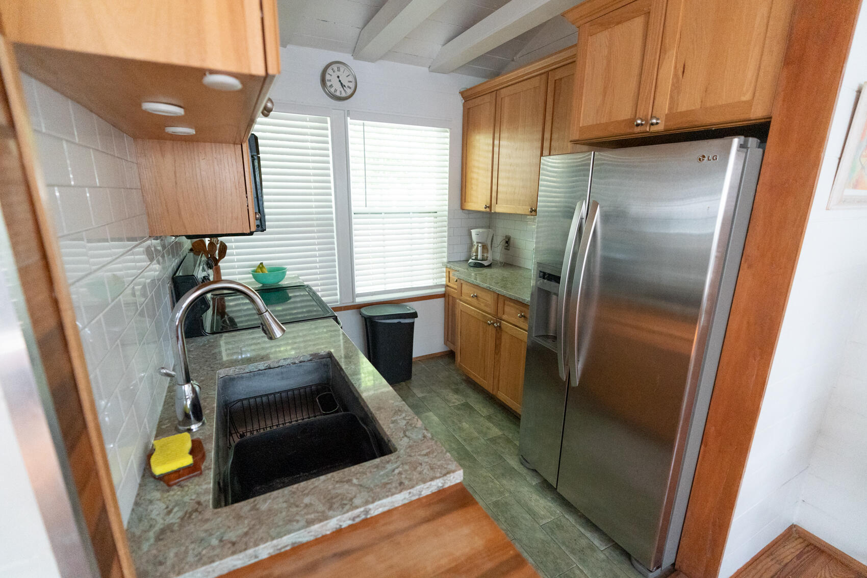 198 Beach Road Tavernier, FL 33070 - Photo 5 of 15 a kitchen with stainless steel appliances granite countertop a refrigerator a sink a stove and cabinets
