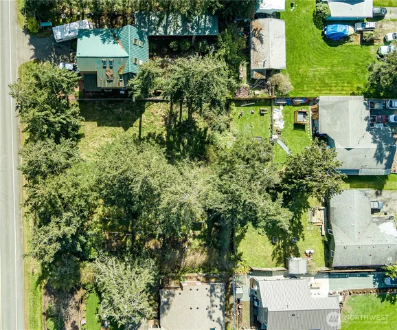 an aerial view of a house with a yard and lake view