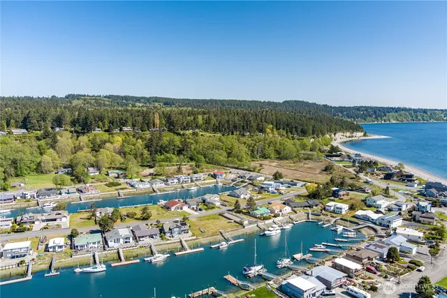 a blue swimming pool with a lawn chairs