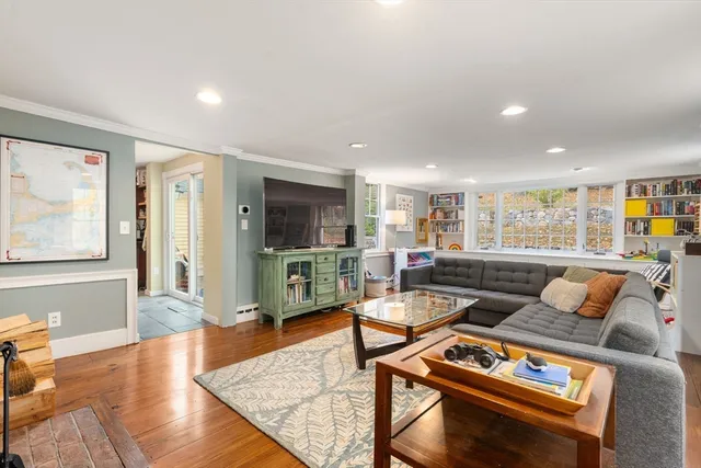 a living room with furniture and a book shelf