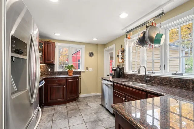 a kitchen with stainless steel appliances granite countertop a refrigerator and a sink