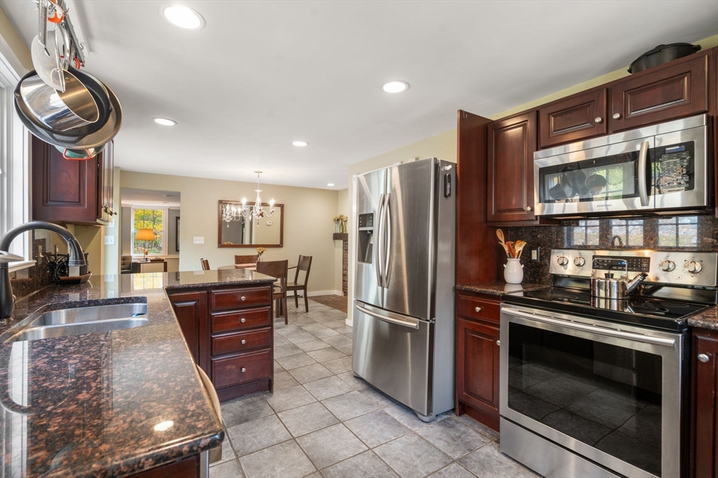 463 Edmands Road Framingham, MA 01701 - Photo 23 of 42 a kitchen with stainless steel appliances granite countertop a stove a refrigerator and a microwave