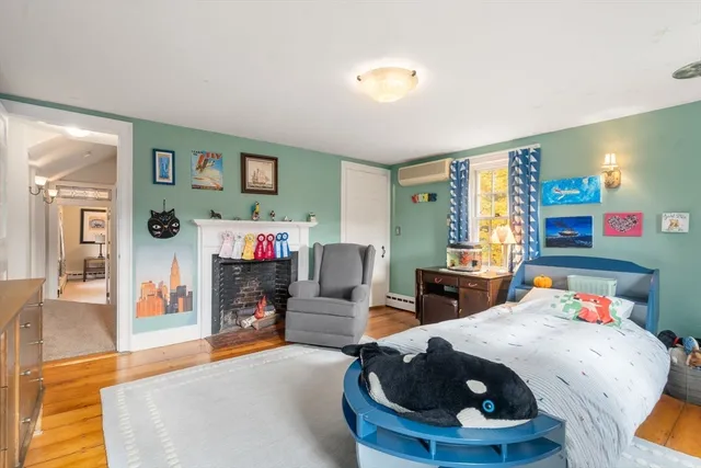 a bedroom with furniture and a large window