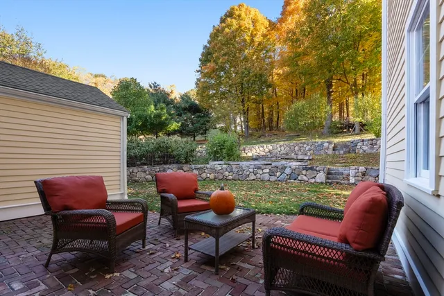 a chairs and a table in the back yard of the house