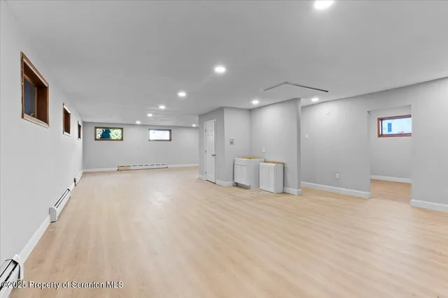 a view of an empty room with wooden floor