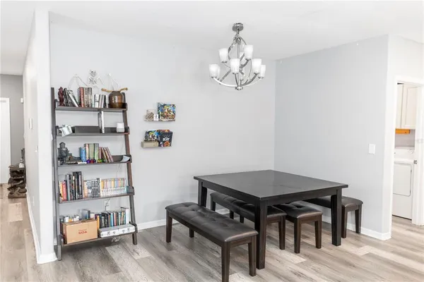 a view of a workspace with furniture and wooden floor