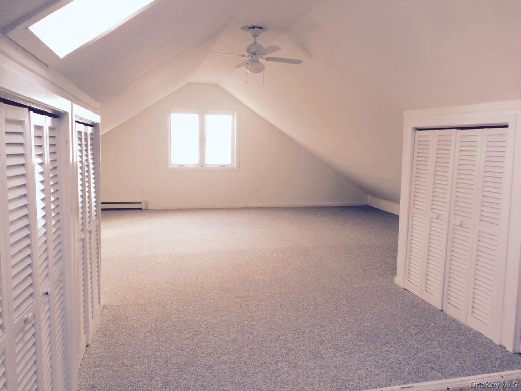 21 Locust Riverhead, NY 11901 - Photo 2 of 14 an empty room with windows and fan