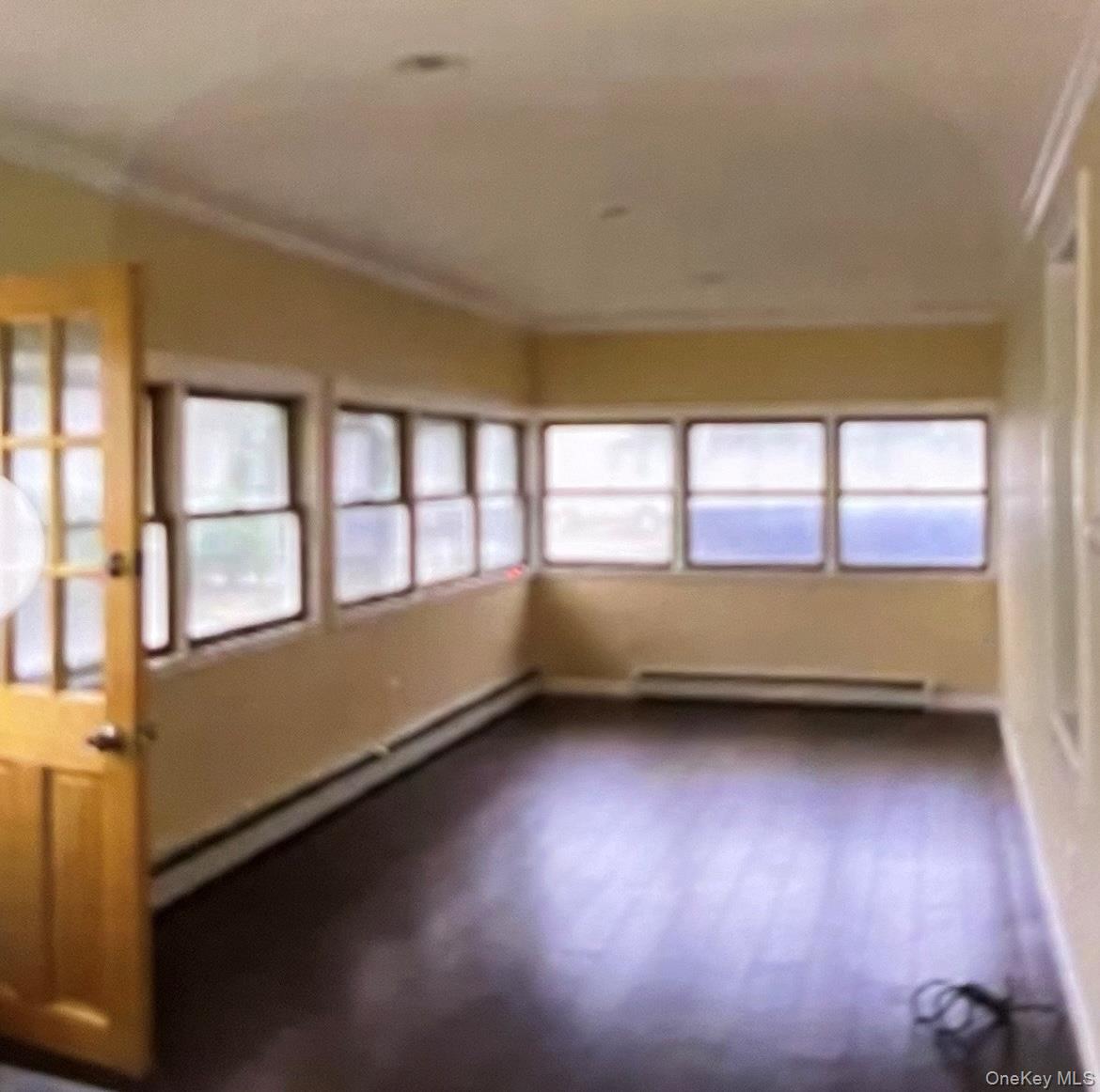21 Locust Riverhead, NY 11901 - Photo 3 of 14 a view of an empty room with a window