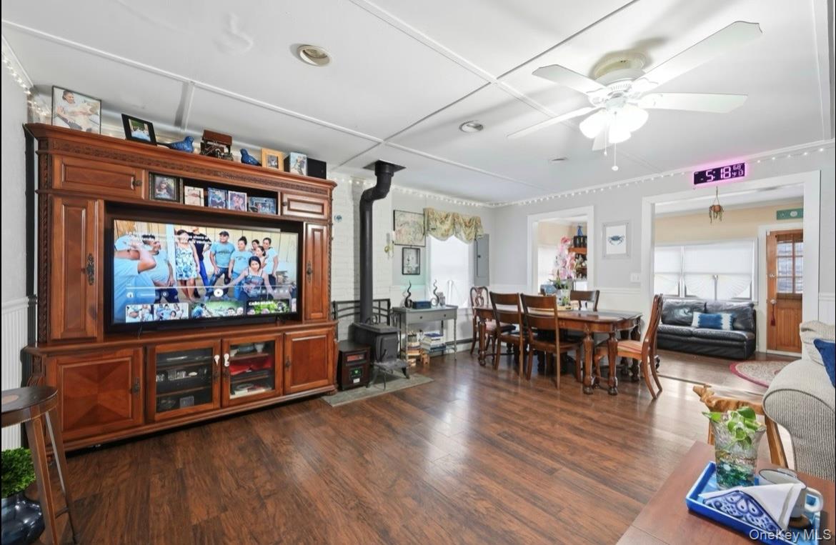 21 Locust Riverhead, NY 11901 - Photo 5 of 14 a living room with furniture and a flat screen tv