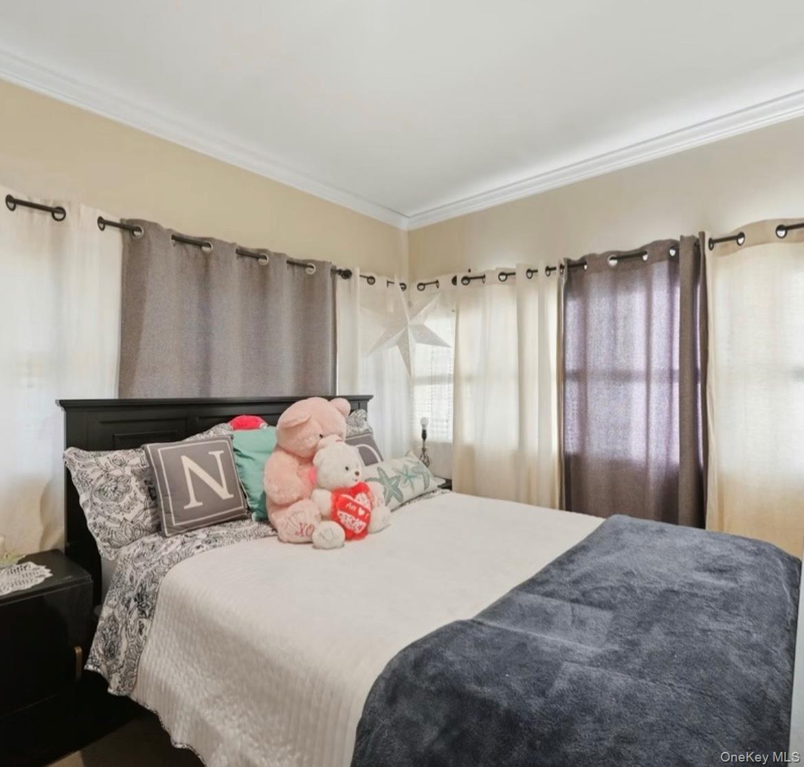 21 Locust Riverhead, NY 11901 - Photo 6 of 14 a bedroom with a bed and a window