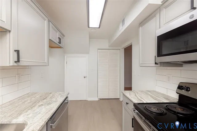 a kitchen with a stove and a microwave